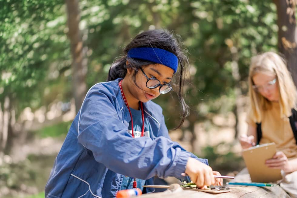 Students taking notes on a clipboard during an outdoor session at Pali Institute